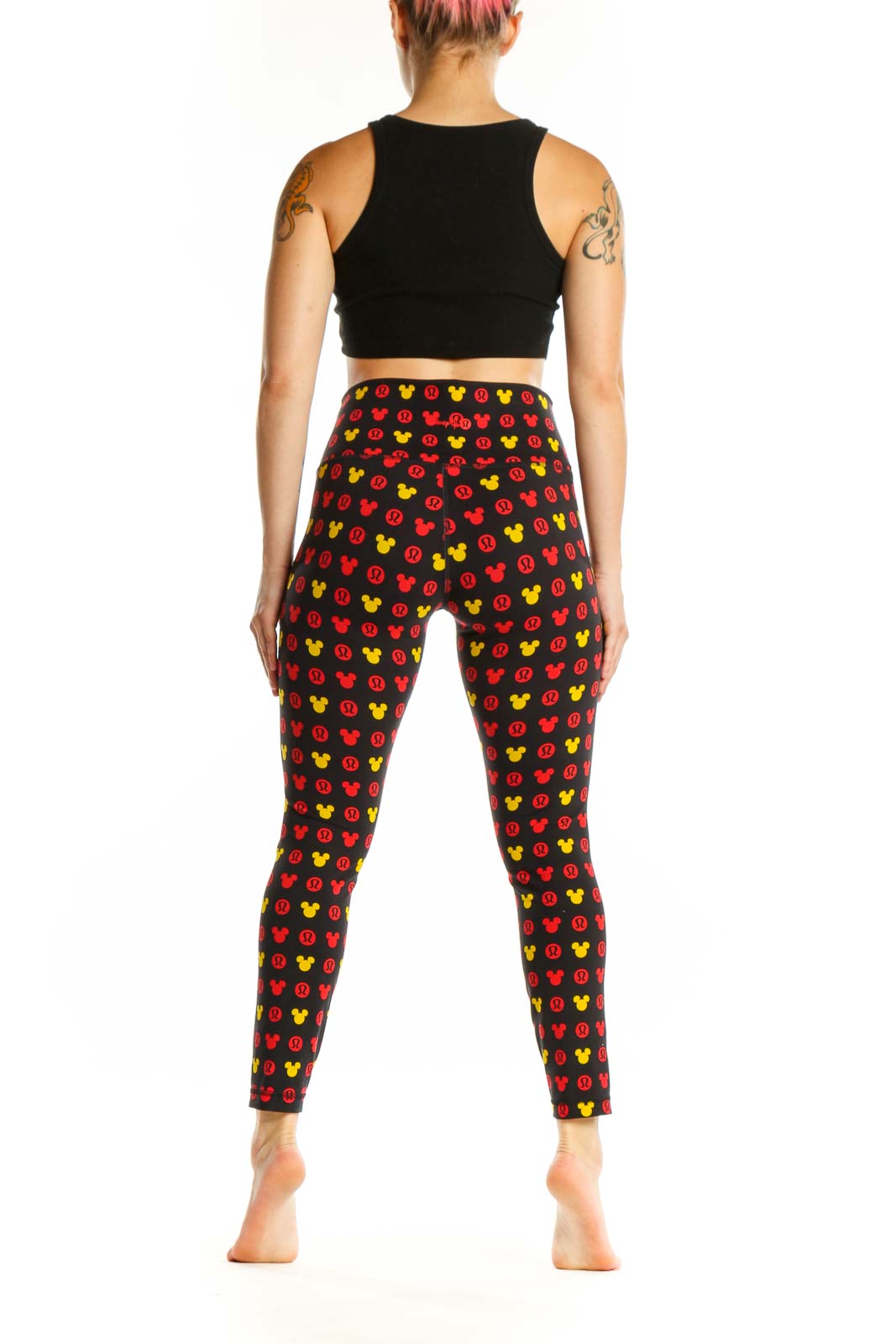 Back view of multicolor Mickey Mouse print Lululemon leggings showing full-length cropped fit and pattern coverage