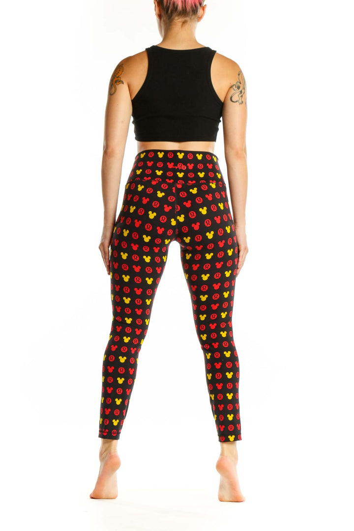 Back view of multicolor Mickey Mouse print Lululemon leggings showing full-length cropped fit and pattern coverage