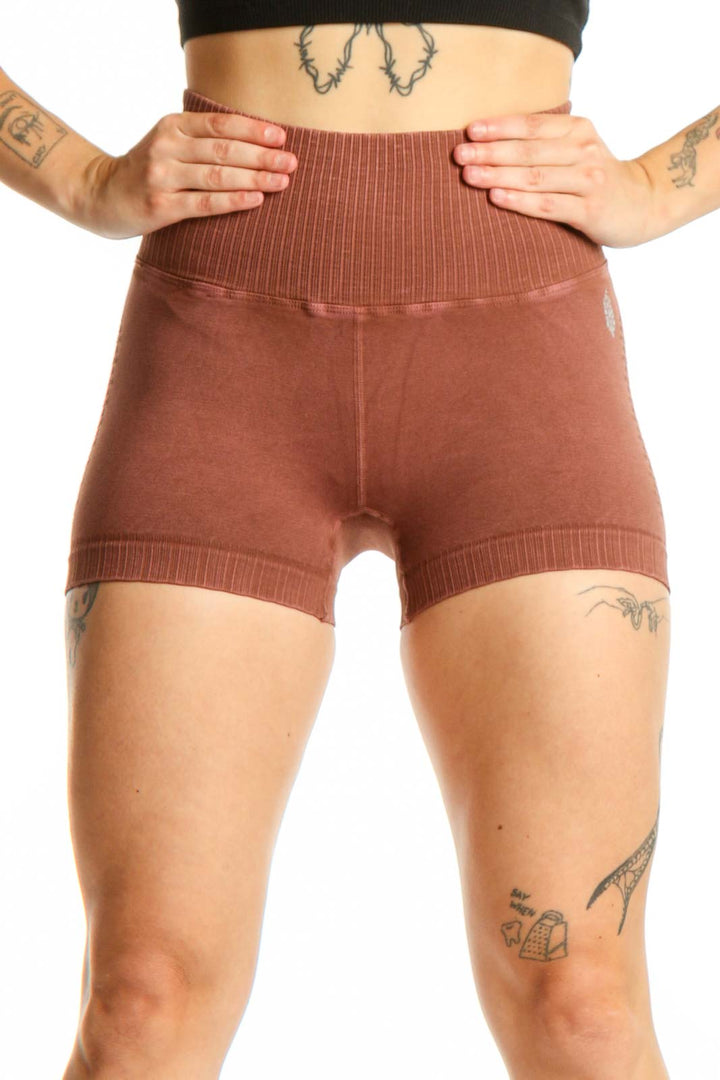 Rust ribbed high-waist activewear shorts front view, showing fitted silhouette and ribbed texture detail