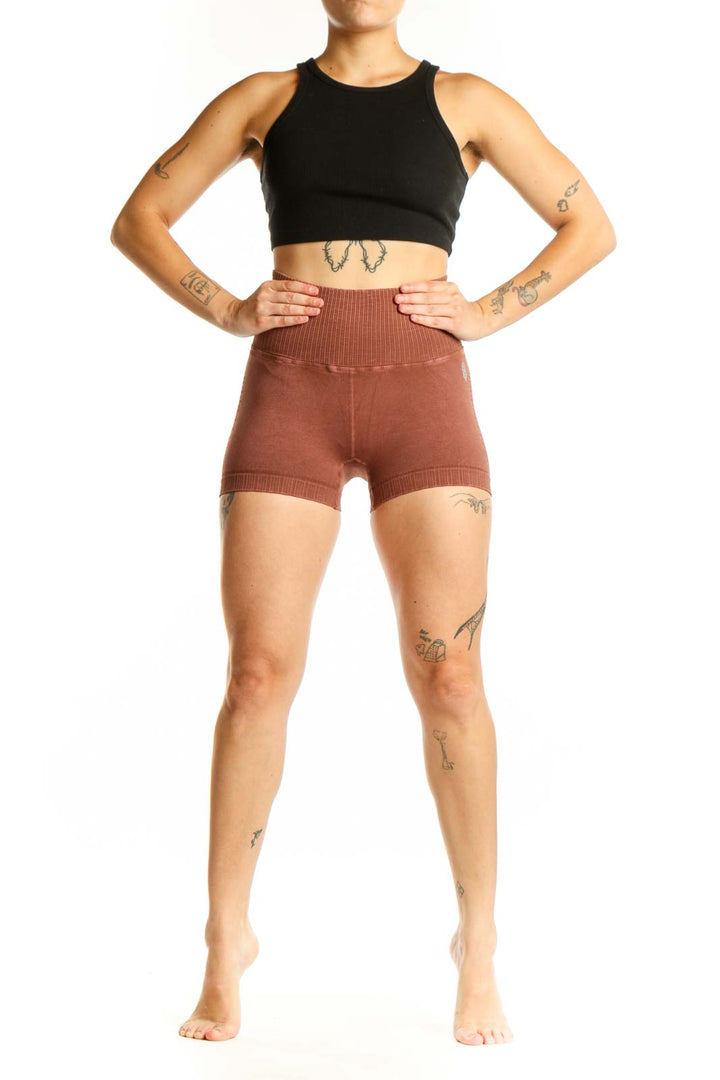 Rust ribbed high-waist activewear shorts front view, showing fitted silhouette and ribbed texture detail