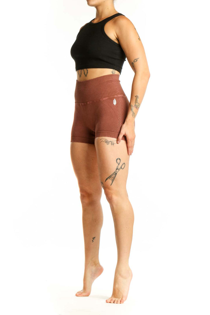 Rust ribbed high-waist activewear shorts front view, showing fitted silhouette and ribbed texture detail