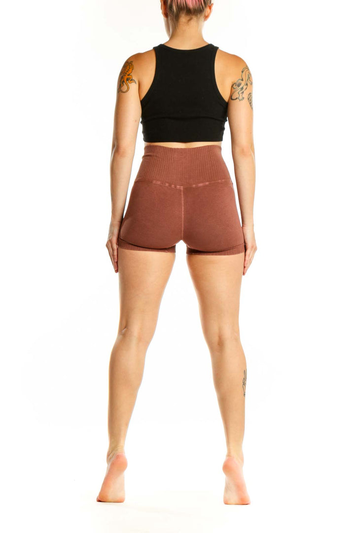 Rust ribbed high-waist activewear shorts back view, displaying high-waist cut and sleek design