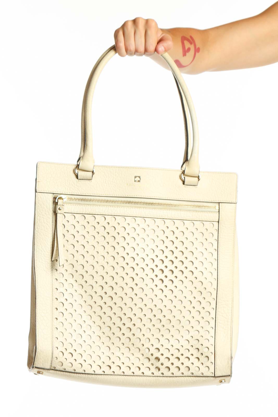 Cream perforated leather Kate Spade tote bag with dual shoulder handles and front zip pocket