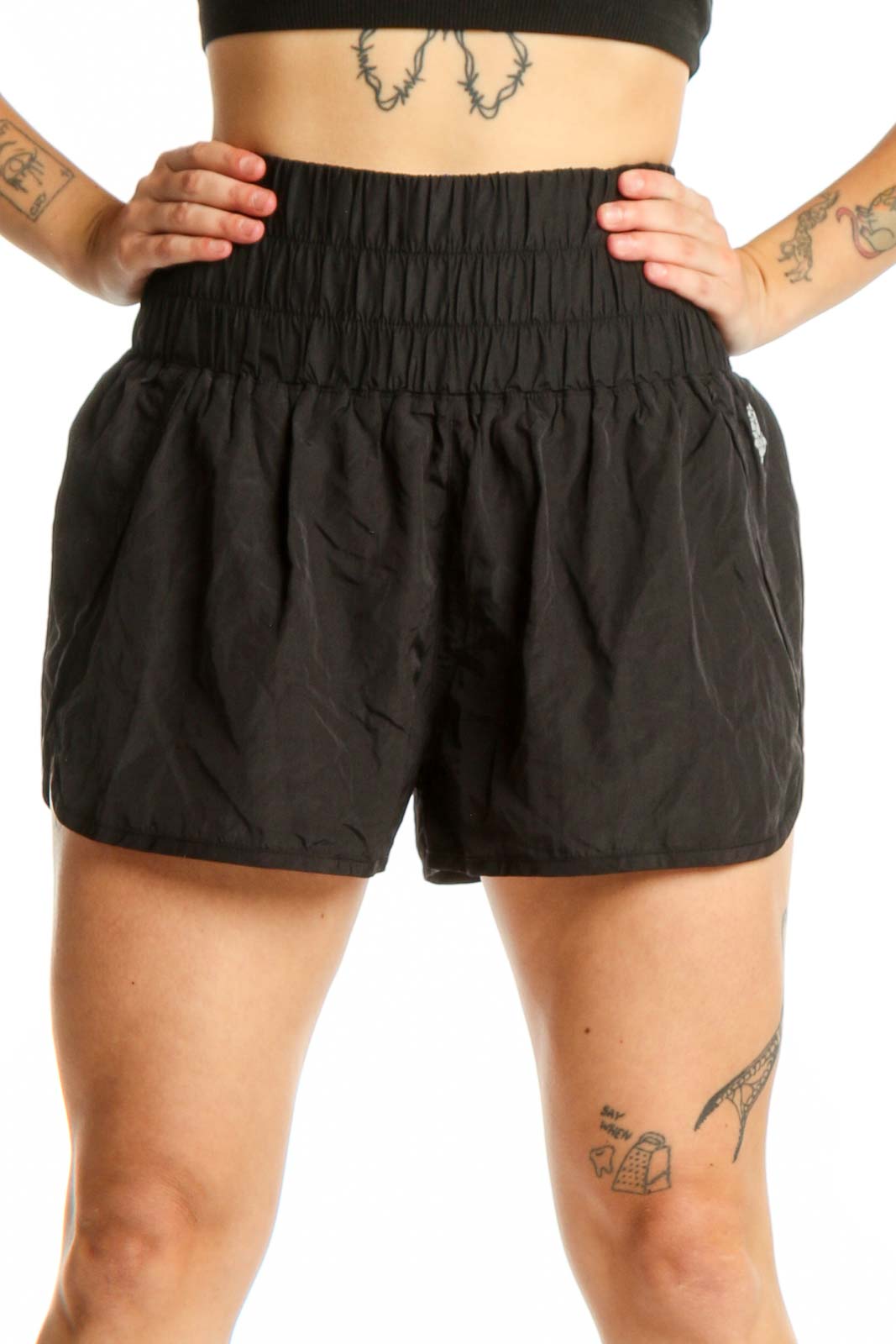 Black athletic shorts with gathered elastic waistband, front view on model