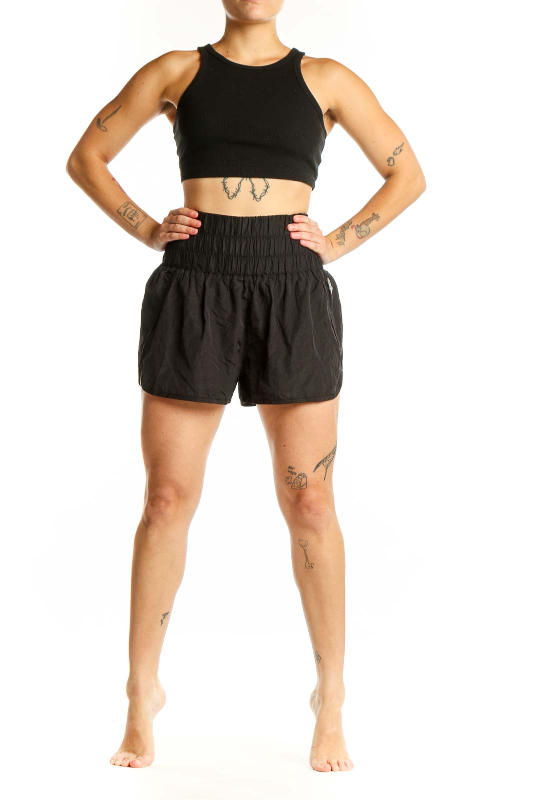Black athletic shorts with gathered elastic waistband, front view on model