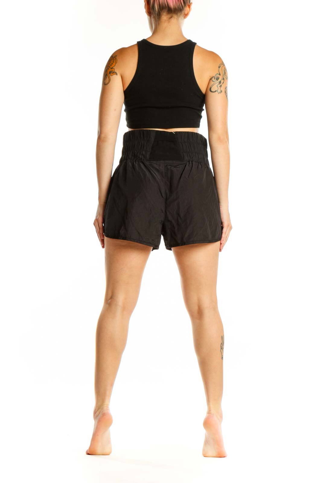 Black athletic shorts with gathered elastic waistband, side view on model