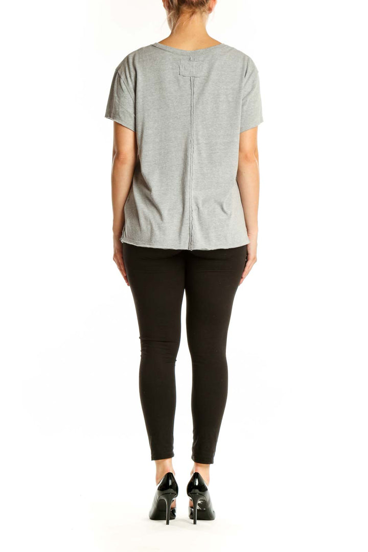 Gray organic cotton short sleeve tee by WE THE FREE, back view on model wearing black leggings