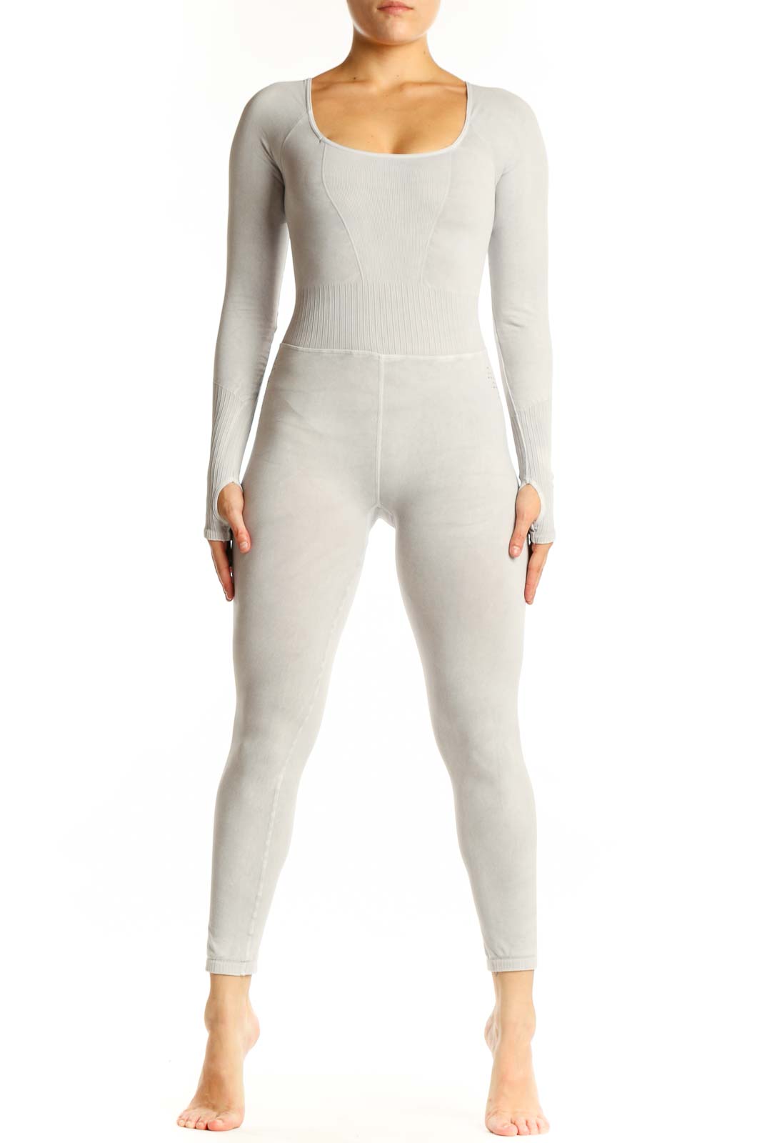 Front view of cream ribbed long sleeve all-in-one jumpsuit with scoop neckline and high-waisted design