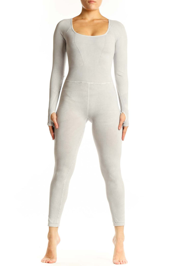Front view of cream ribbed long sleeve all-in-one jumpsuit with scoop neckline and high-waisted design