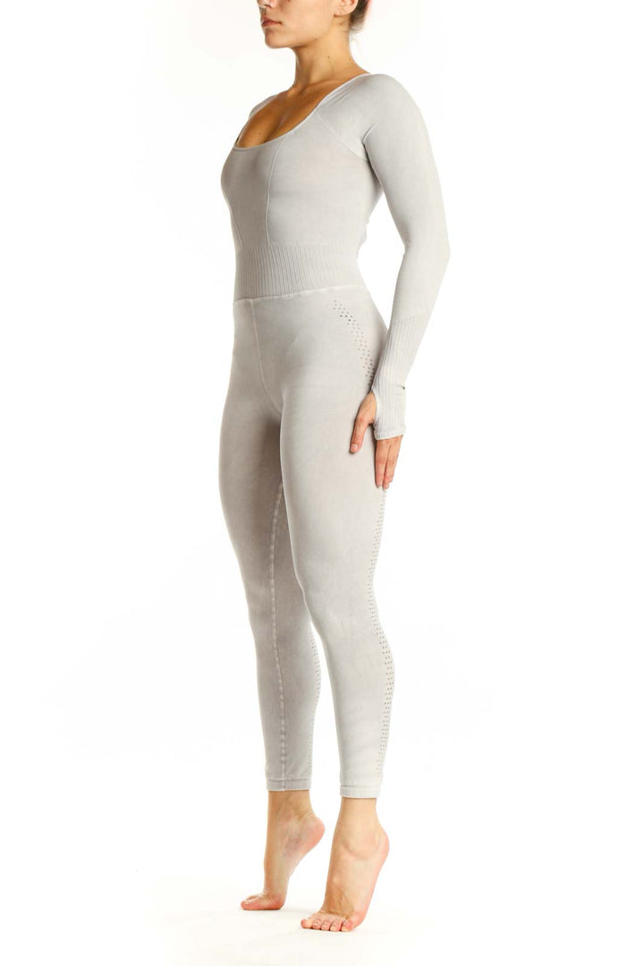 Front view of cream ribbed long sleeve all-in-one jumpsuit with scoop neckline and high-waisted design