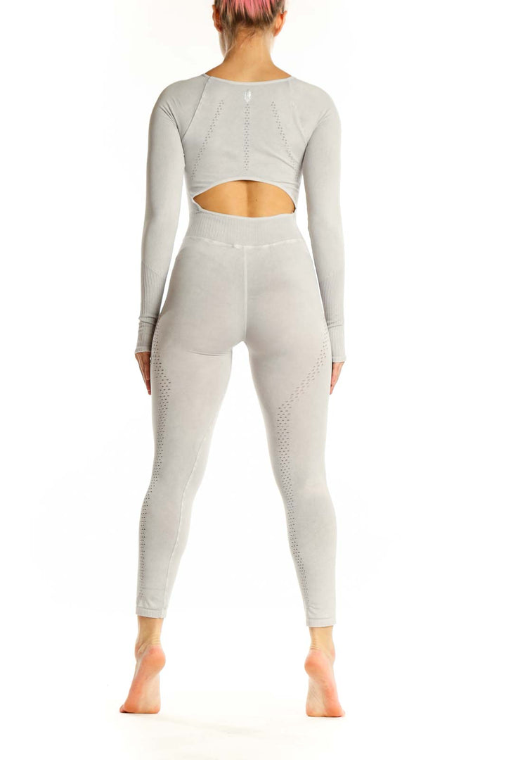 Back view of cream ribbed all-in-one jumpsuit showing seamless construction and cropped ankle length