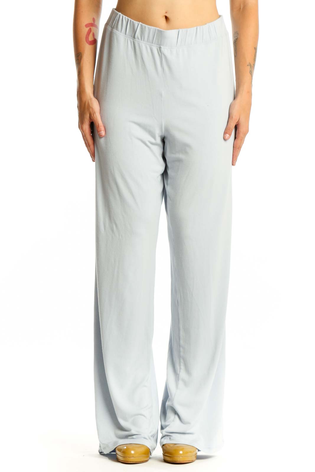 Gray wide leg pants with elastic waistband, front view on model wearing black crop top