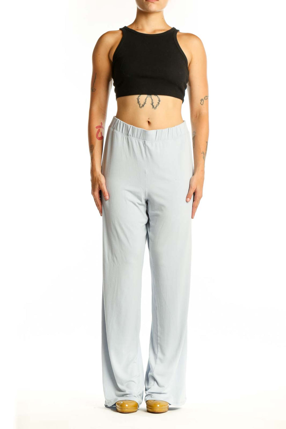 Gray wide leg pants with elastic waistband, front view on model wearing black crop top
