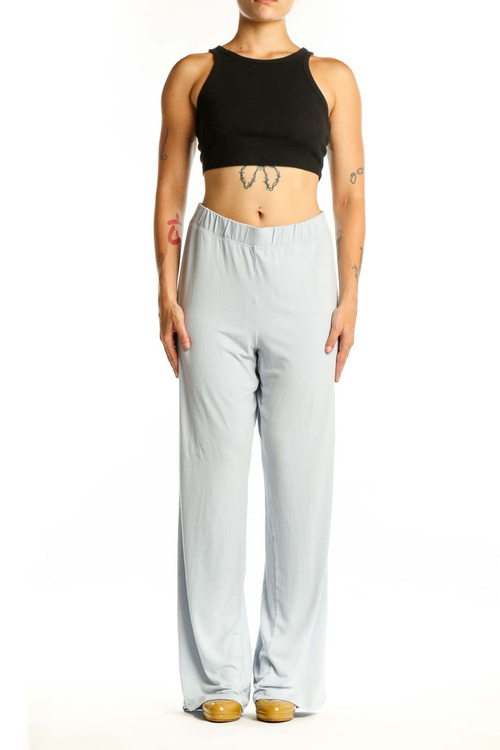 Gray wide leg pants with elastic waistband, front view on model wearing black crop top