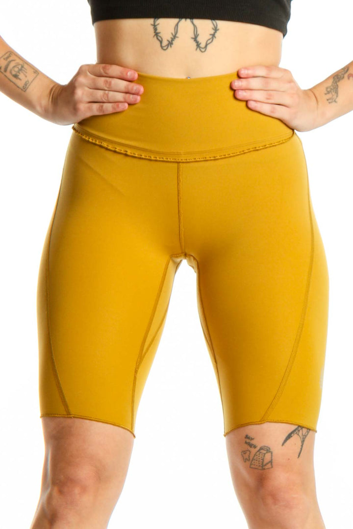 Yellow high-waist bike shorts front view showing form-fitting silhouette and premium fabric quality