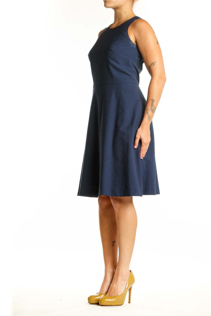 Navy sleeveless A-line dress with crew neckline, front view on model