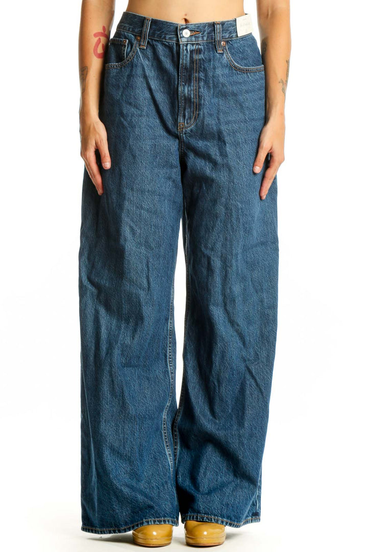 Front view of blue wide-leg denim jeans with five-pocket styling and button fly closure