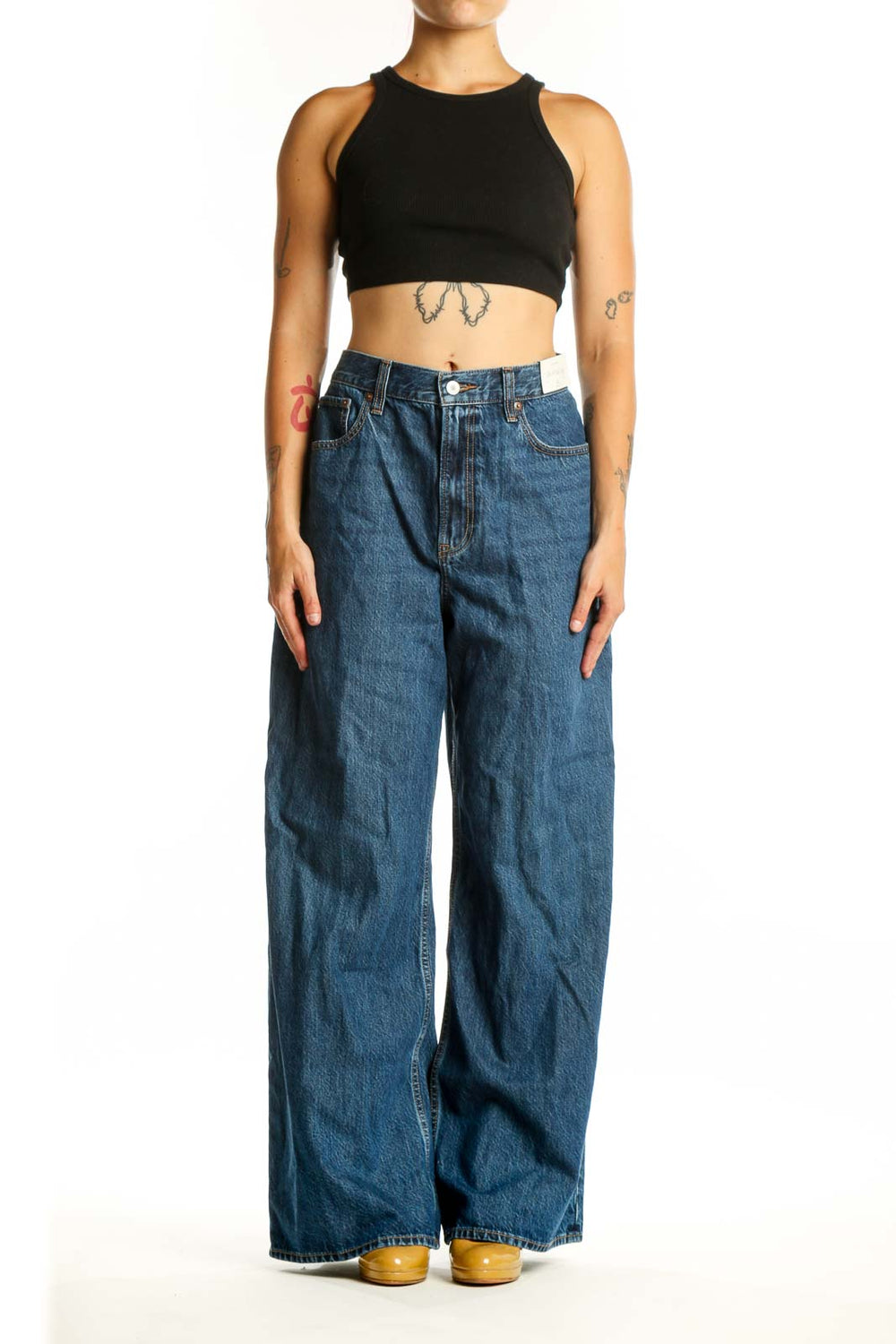Front view of blue wide-leg denim jeans with five-pocket styling and button fly closure