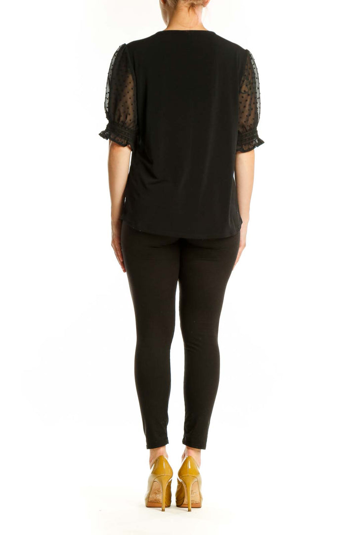 Black V-neck puff sleeve top with dotted mesh details by Adrianna Papell, back view