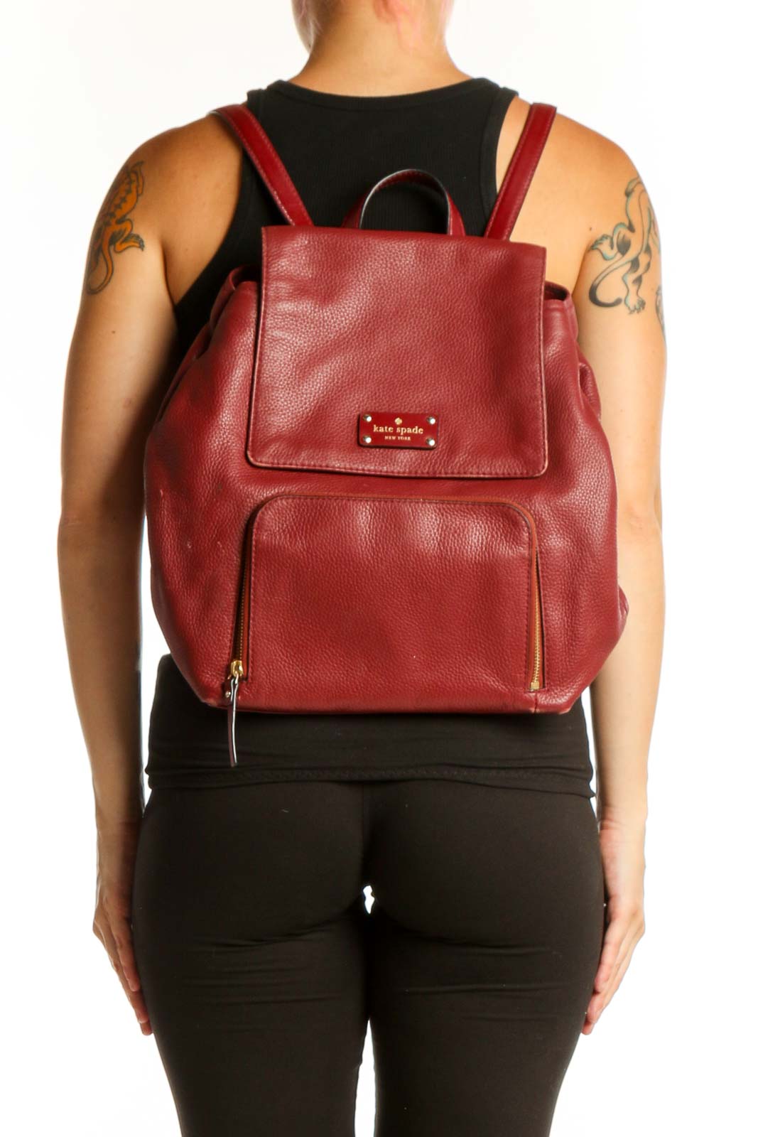 Burgundy leather Kate Spade backpack with top handle and front pocket, displayed from front view