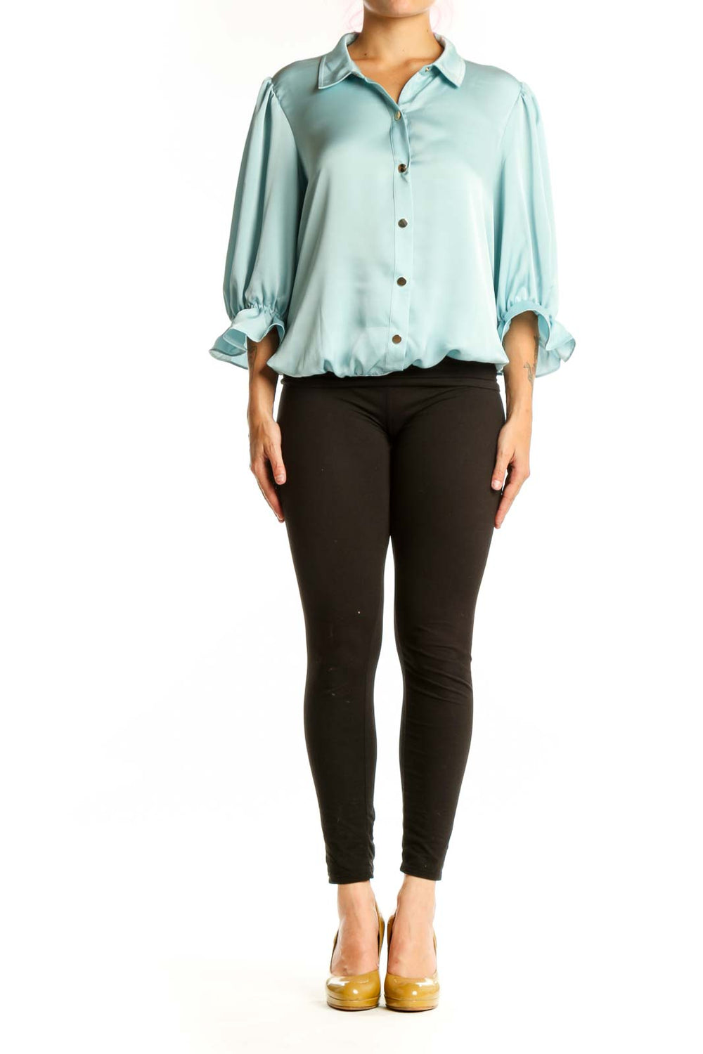 Front view of pale blue puff sleeve button-up blouse with rolled cuffs and brown buttons