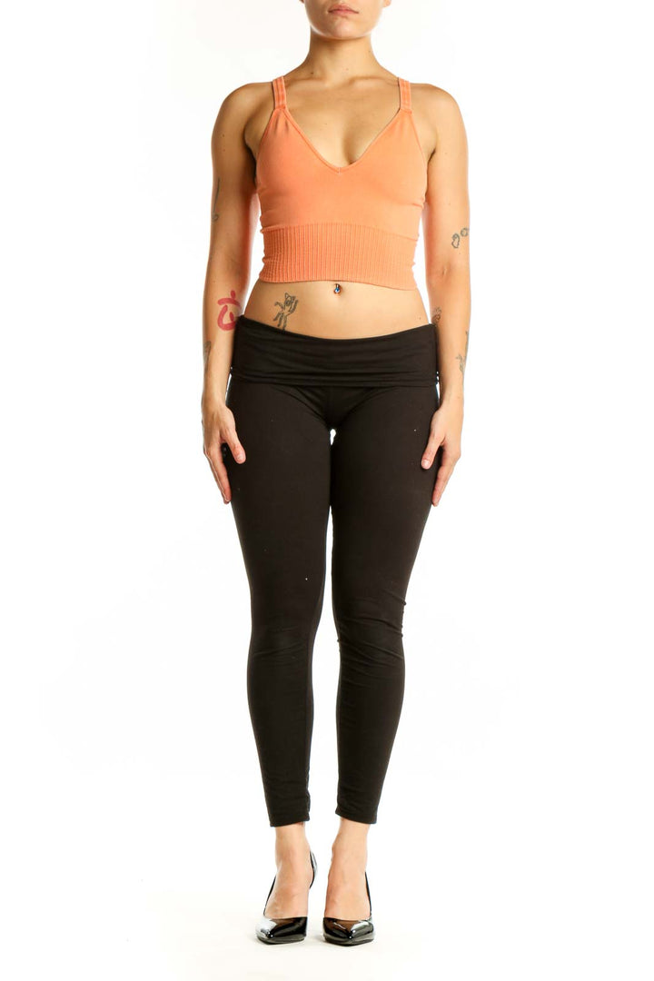 Peach ribbed crop tank top with V-neckline and ribbed midsection detail, front view