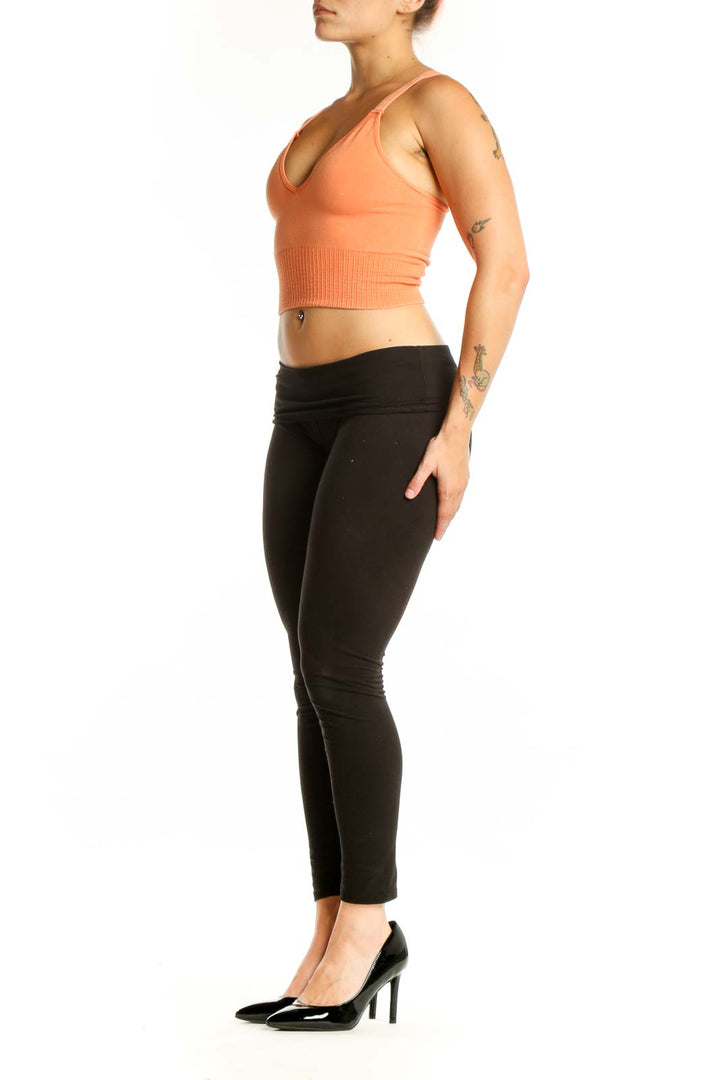Peach ribbed crop tank top with V-neckline and ribbed midsection detail, front view