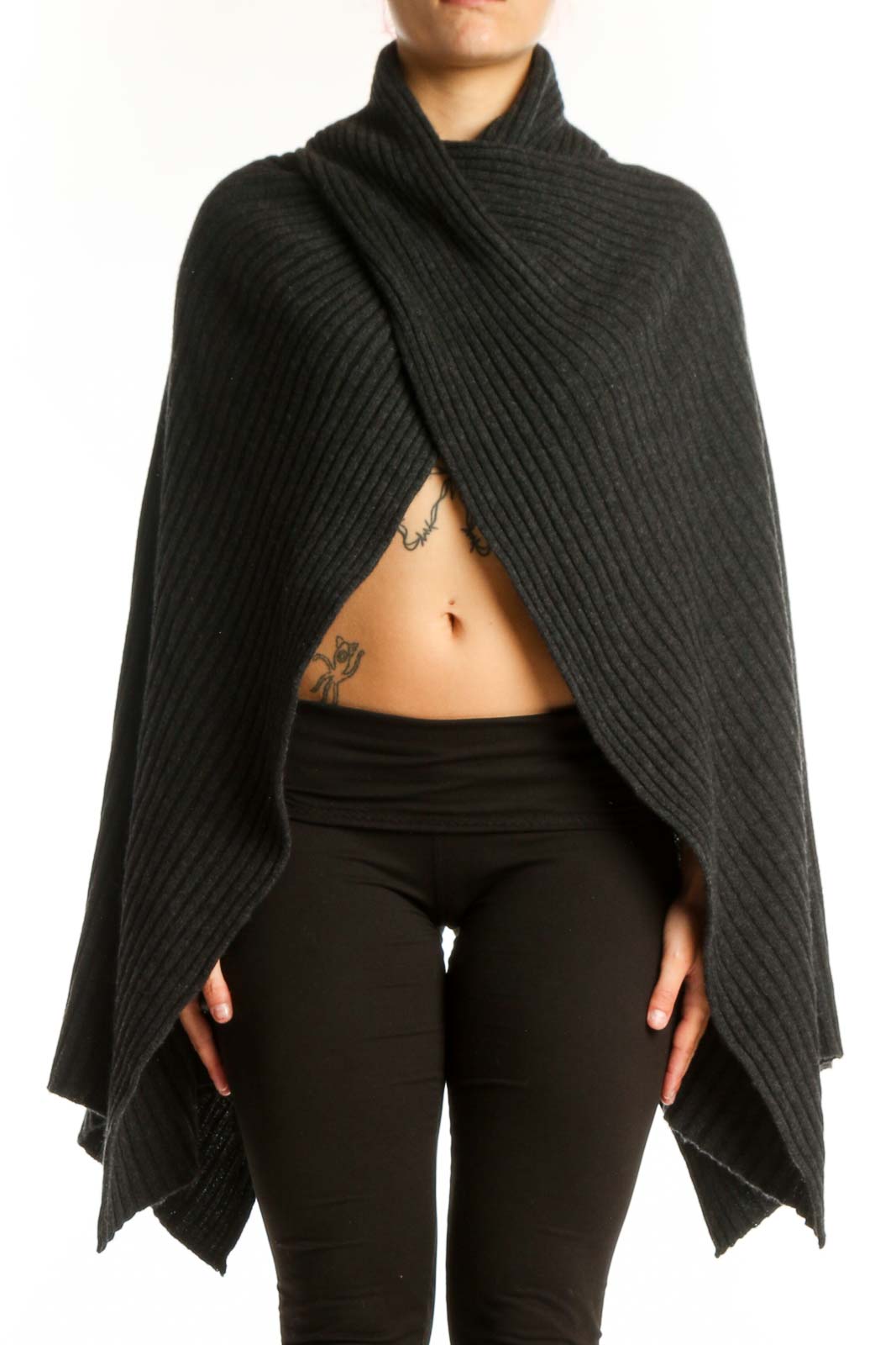 Black cashmere ribbed wrap poncho with turtleneck collar draped over black leggings, front view