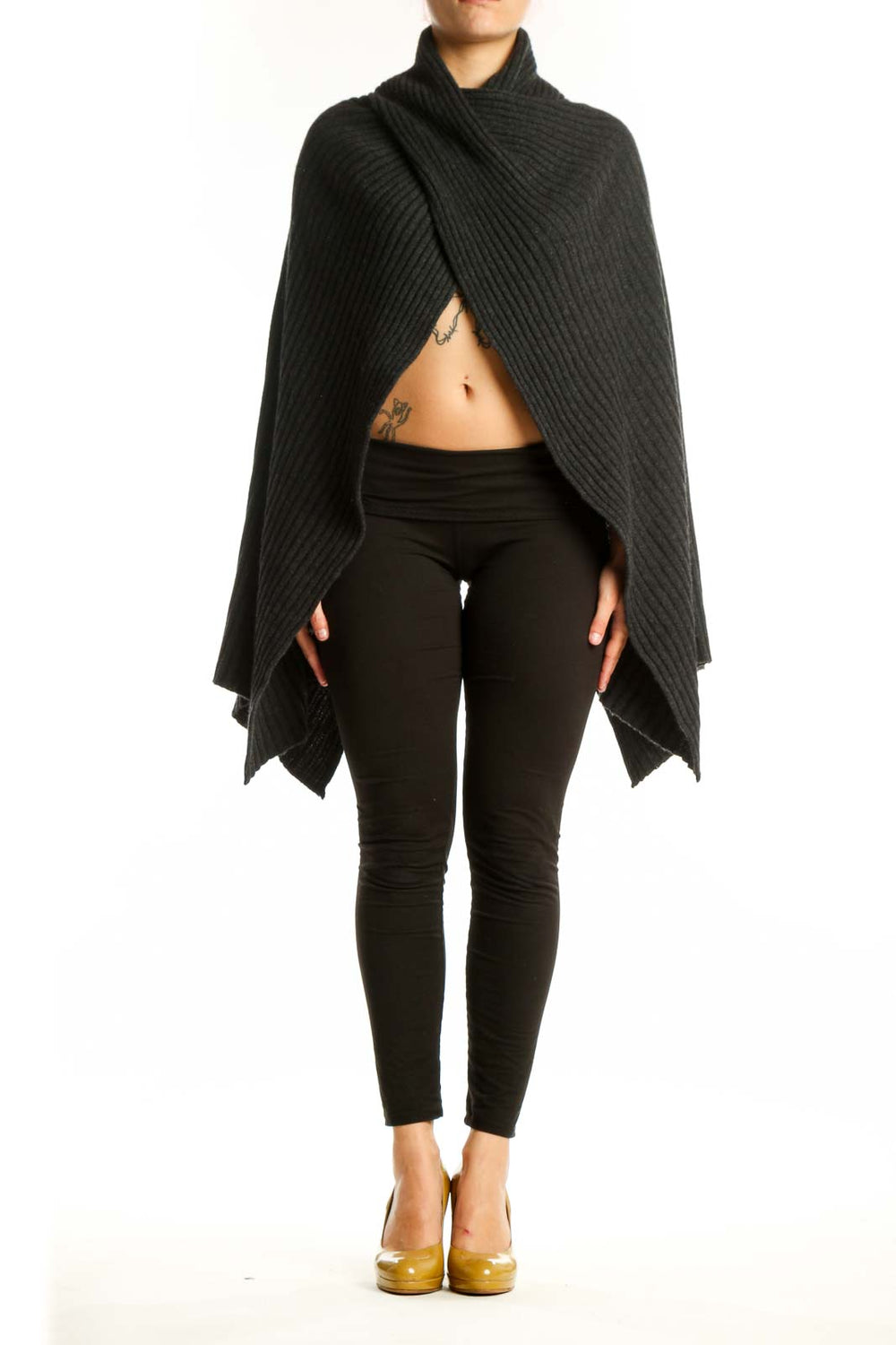 Black cashmere ribbed wrap poncho with turtleneck collar draped over black leggings, front view