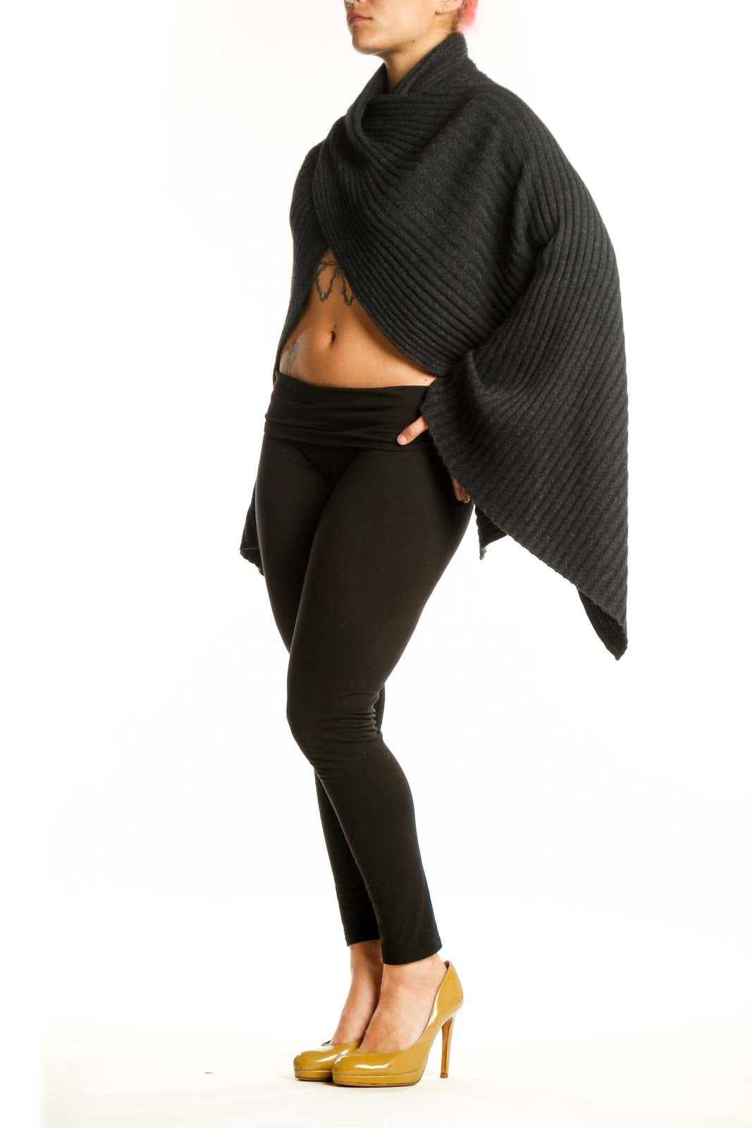 Black cashmere ribbed wrap poncho with turtleneck collar draped over black leggings, front view