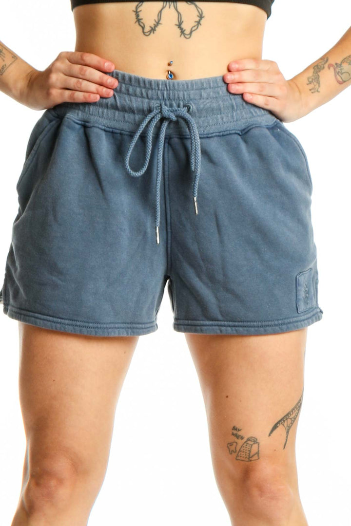 Blue denim activewear shorts with drawstring waistband and cargo pockets, front view
