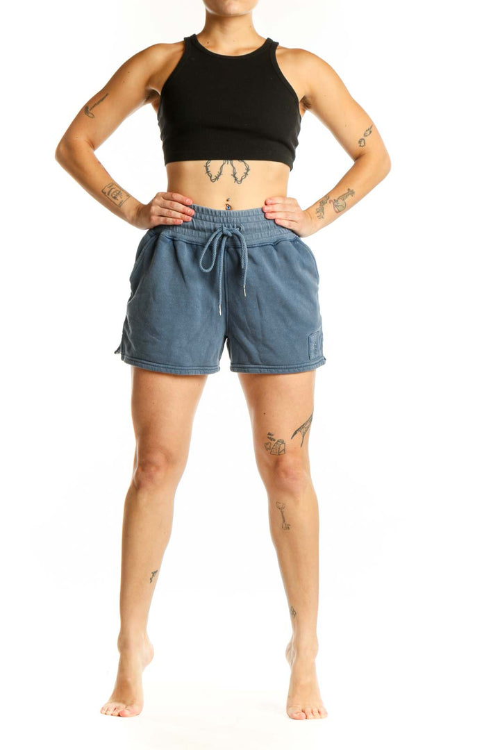 Blue denim activewear shorts with drawstring waistband and cargo pockets, front view