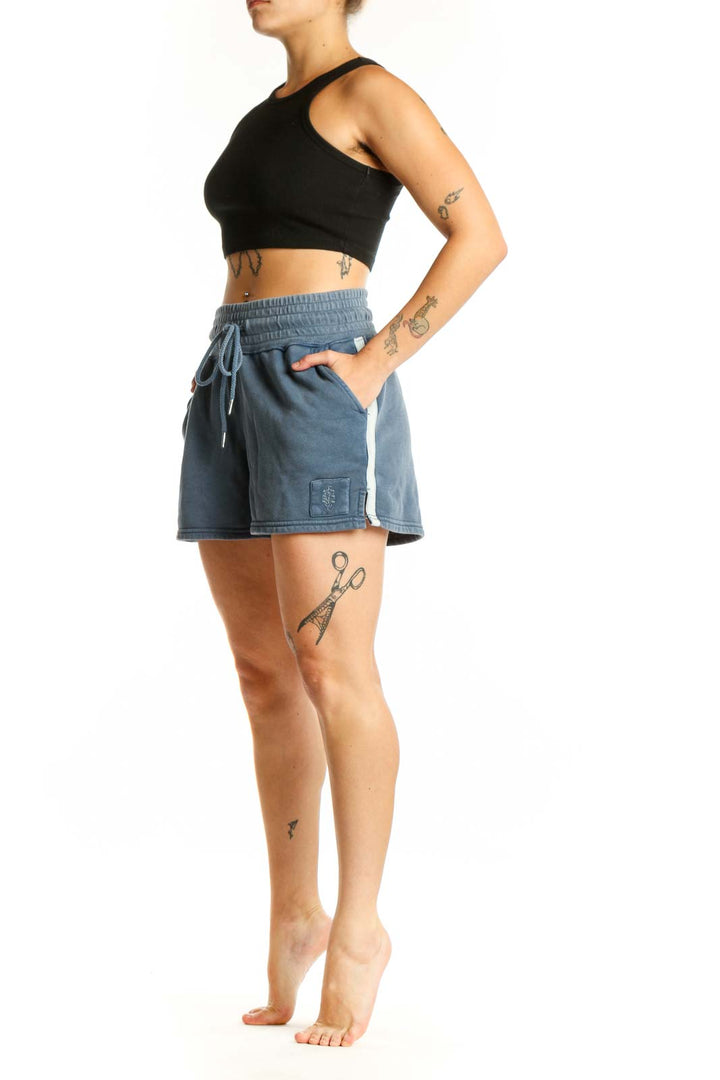 Blue denim activewear shorts with drawstring waistband and cargo pockets, front view