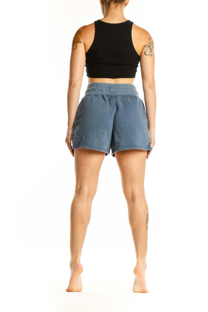 Blue denim activewear shorts with side pockets, back view on model
