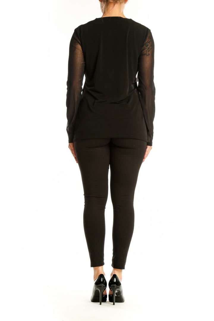 Black V-neck long sleeve top with sheer mesh sleeves by Carmen Marc Valvo, back view