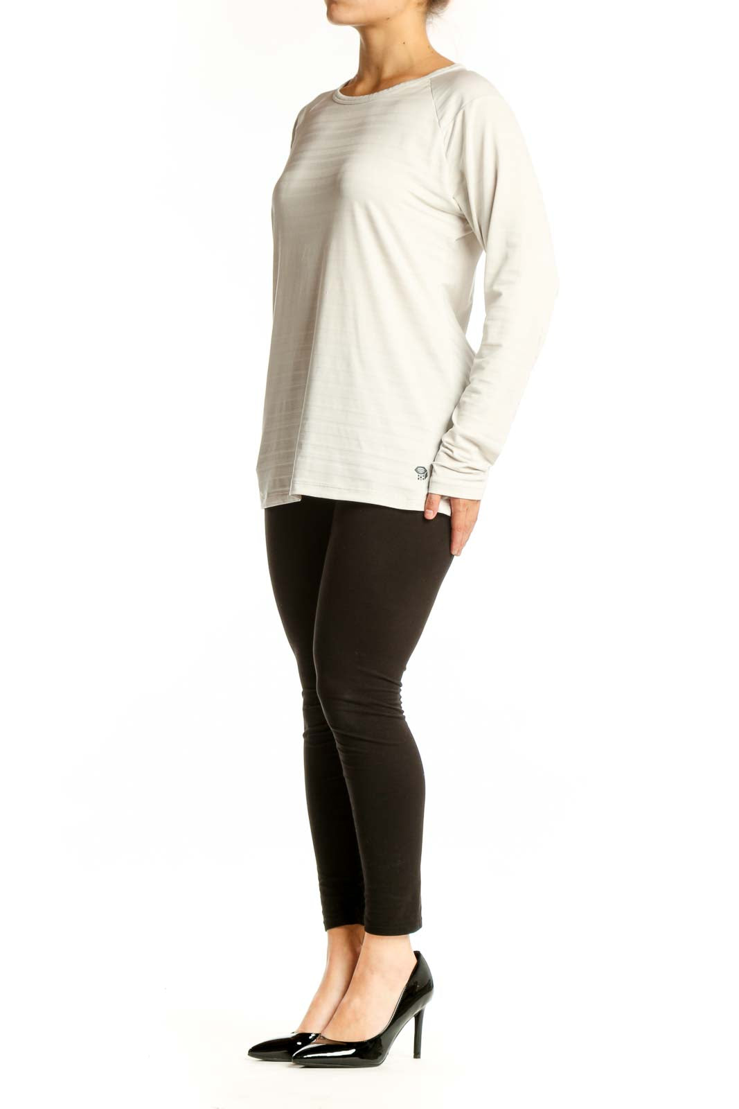 Cream long sleeve athletic top with crew neckline, front view on model