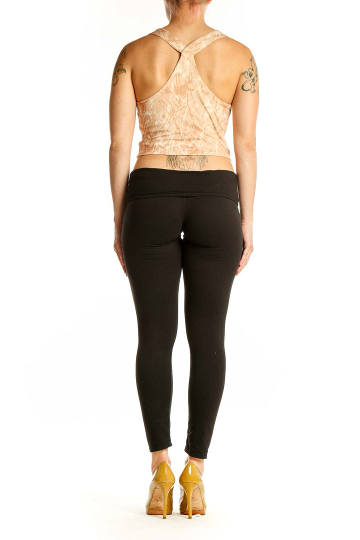 Beige textured crop tank top, back view showing sleeveless design and fitted silhouette