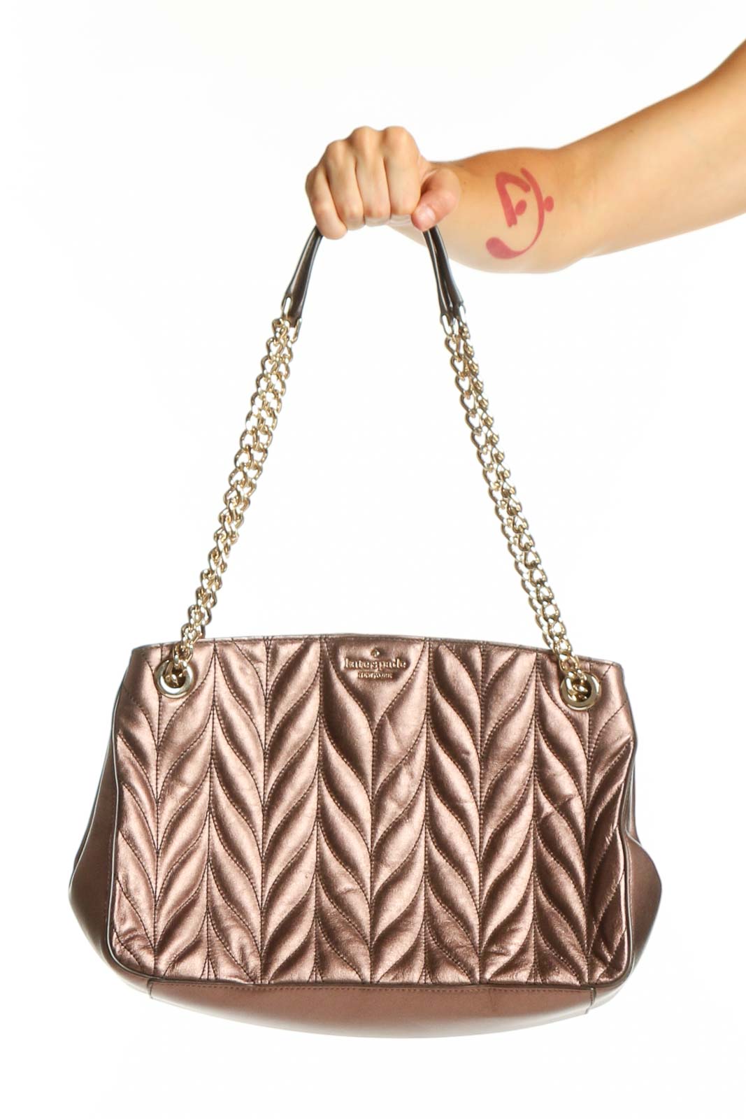 Rose gold quilted leather shoulder bag by Kate Spade with dual chain straps and chevron pattern, front view