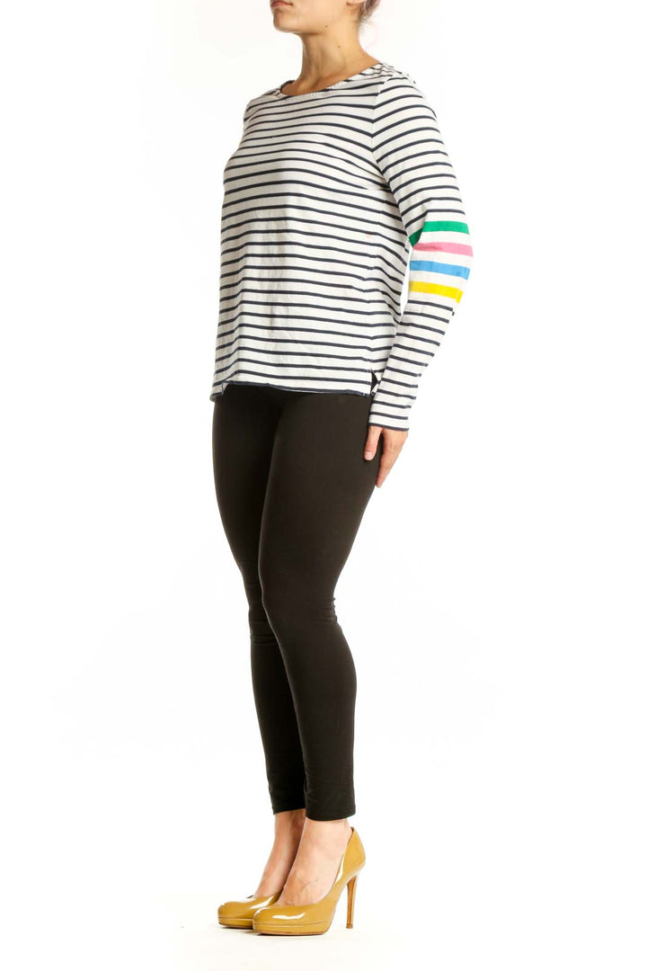 Navy and white striped long sleeve cotton top with colorful rainbow stripes on sleeves, front view