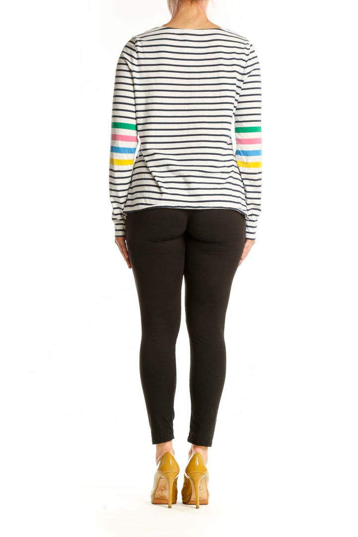 Navy and white striped long sleeve cotton top with rainbow sleeve accents, back view