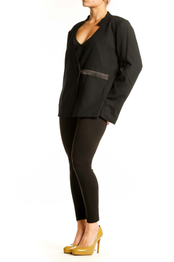 Black wrap blazer with satin trim and V-neckline by Halston Heritage, front view