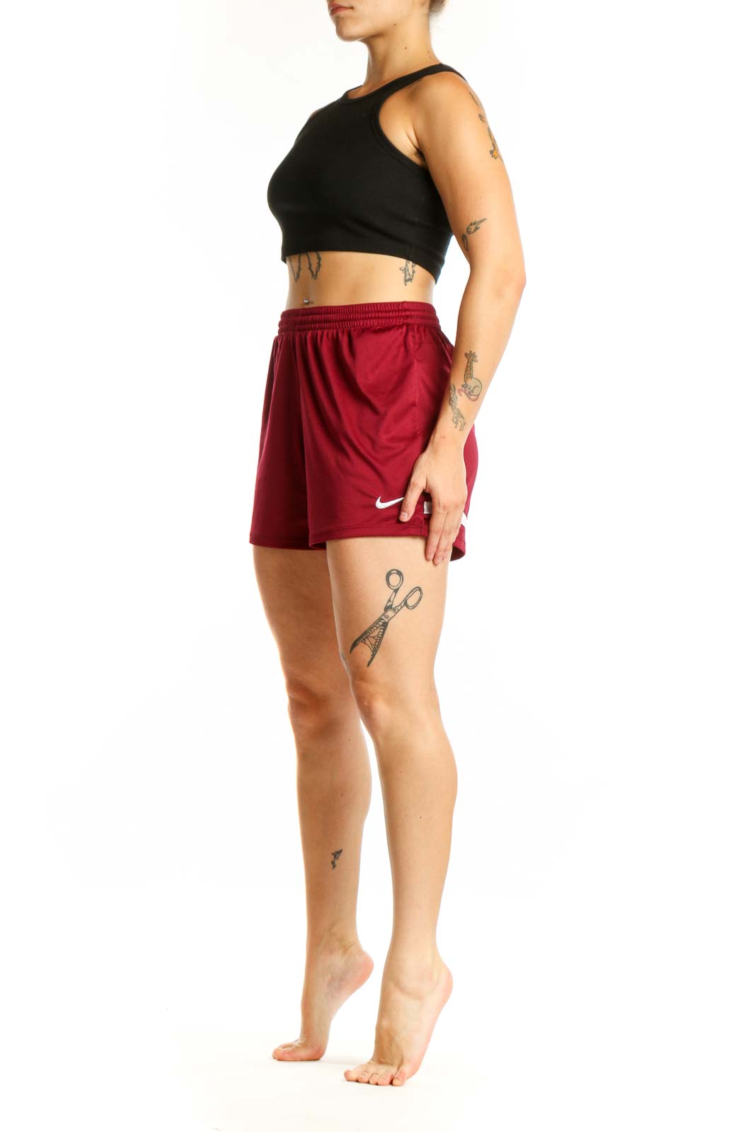 Burgundy Nike athletic shorts front view with elastic waistband and Swoosh logo