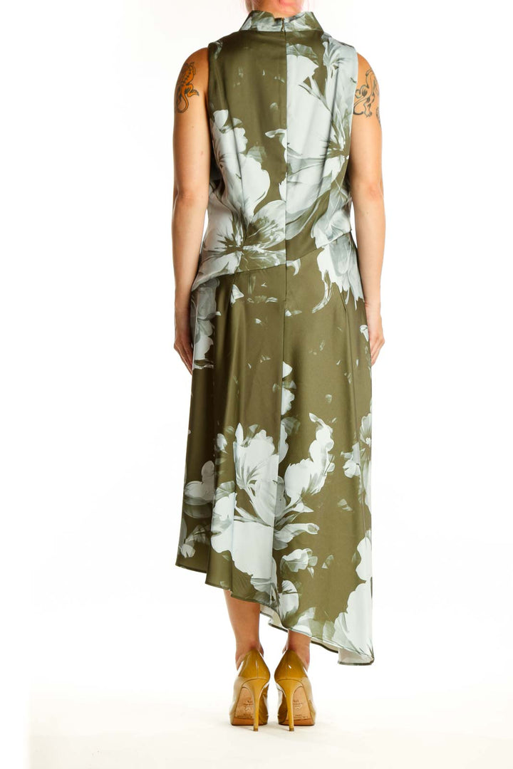 Back view of olive floral asymmetrical dress showing flowing hemline and sleeveless design