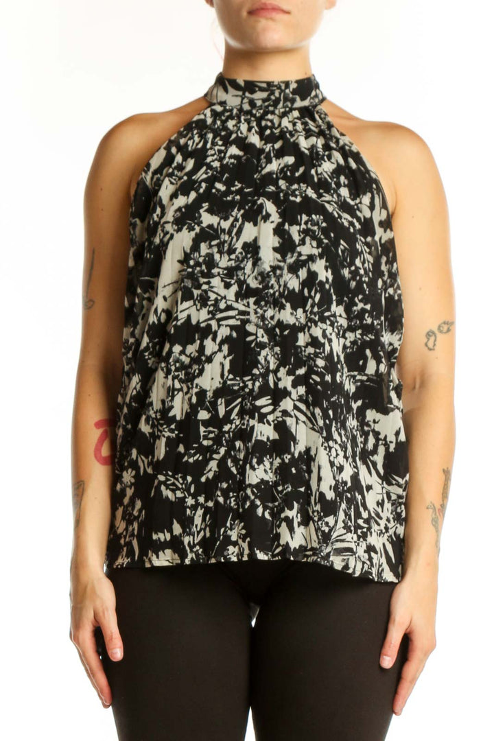 Black and cream abstract halter top with artistic print, front view on model