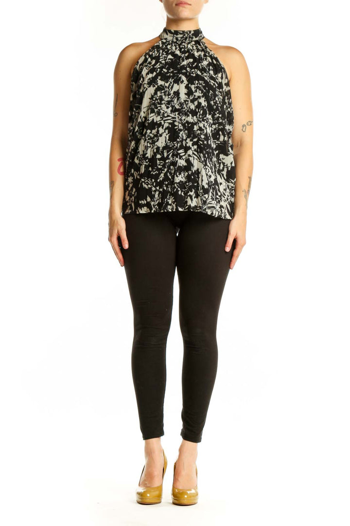 Black and cream abstract halter top with artistic print, front view on model