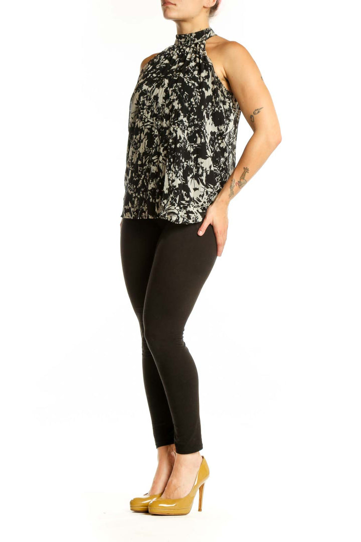 Black and cream abstract halter top with artistic print, front view on model