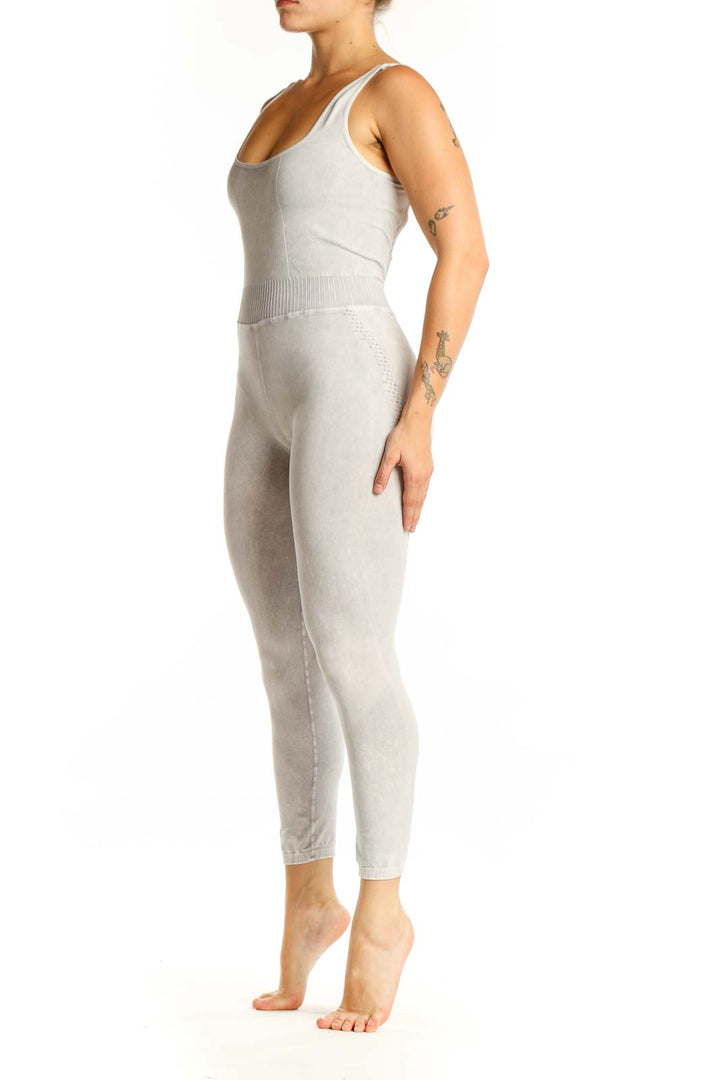 Front view of cream ribbed tank all-in-one jumpsuit with scoop neckline and cropped leggings
