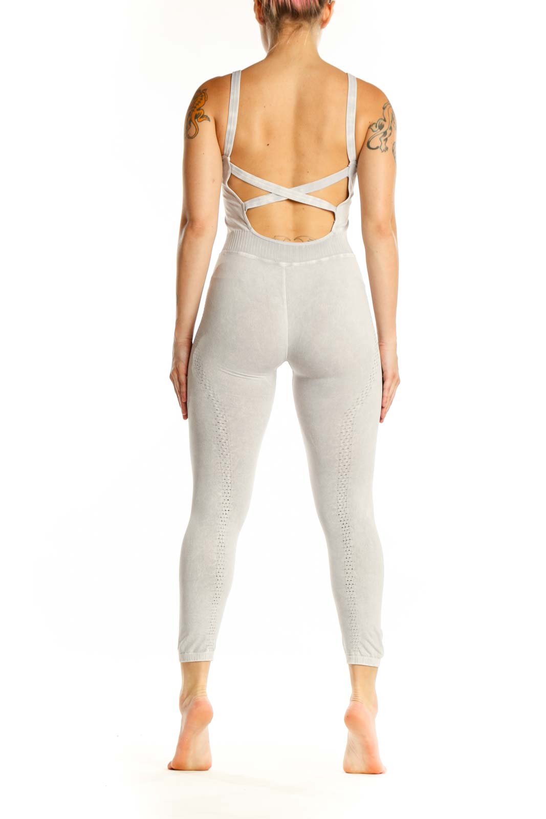 Back view of cream ribbed tank all-in-one jumpsuit showing fitted silhouette and high-waisted design