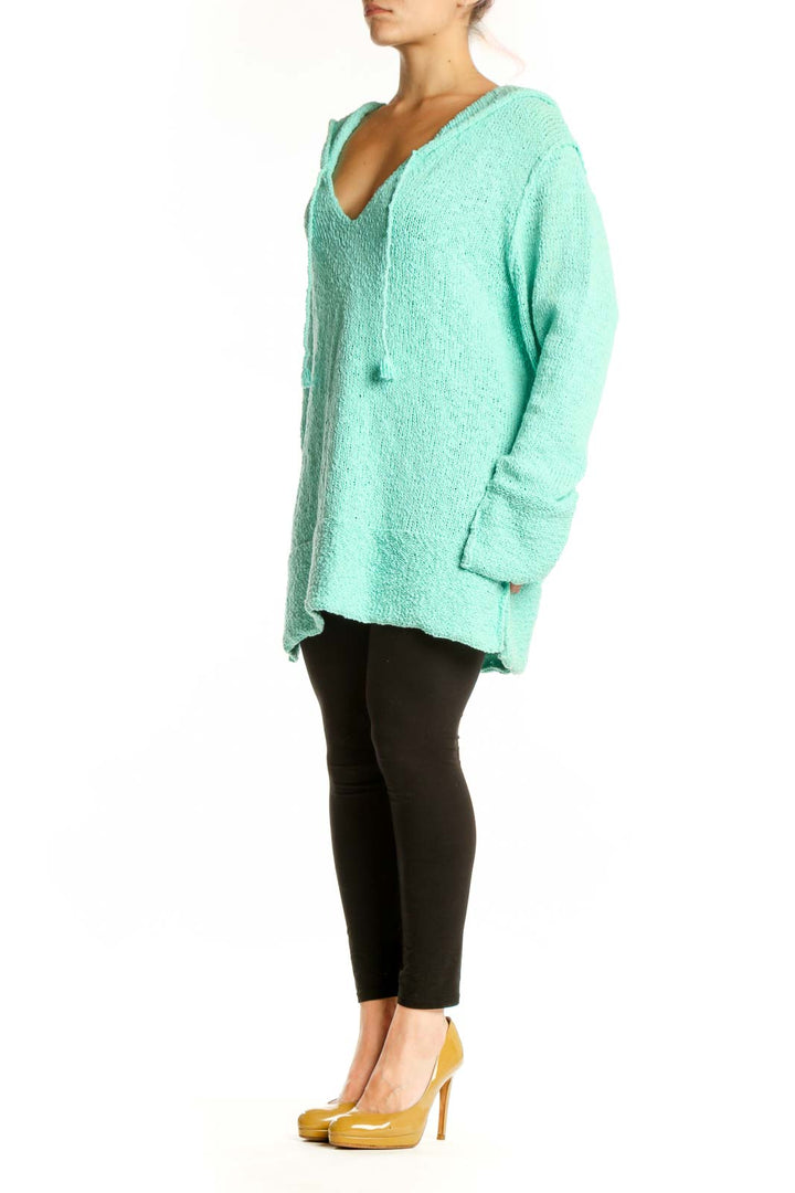 Front view of mint green hooded V-neck knit sweater with textured fabric and oversized fit