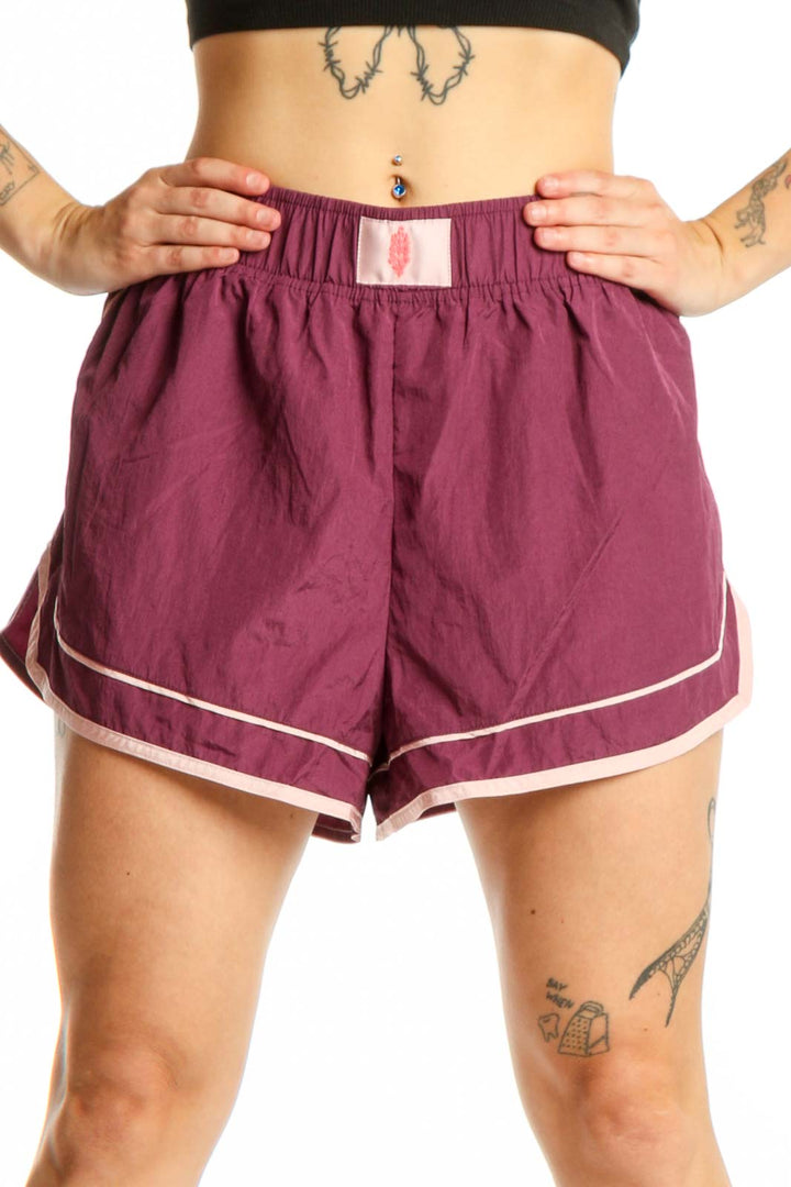 Burgundy athletic shorts with white contrast trim and elastic waistband, front view